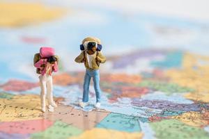 Bangkok, Thailand, July 30, 2022 Miniature people,Backpacker enjoy to discovery journey travel at amazing on world map. photo