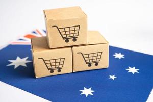 caja con el logotipo del carrito de compras y la bandera de australia, importación, exportación, compras en línea o comercio electrónico, servicio de entrega de finanzas, tienda, envío de productos, comercio, concepto de proveedor. foto