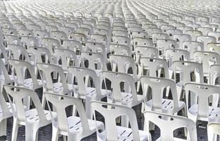Behind a large number of white plastic chairs were set up for watching the show. photo