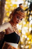 Portrait of Asian woman wearing a gold crown and gold necklace with her gorgeous make-up in black dress photo