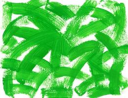 Brushstrokes of bright green paint on textured horizontal white canvas. Abstract acrylic, gouache or tempera green paint texture. Artistic background with place for text. photo
