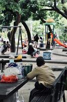 Badung, Bali - January 13 2023 You can see a mother selling snacks around a children's playground photo