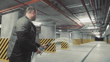 A firefighter is testing the fire safety system. Test start of water with a fire hose in the underground parking lot video