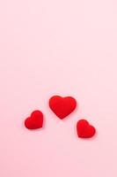 Valentine's Day design concept of red heart on pink background. photo