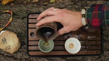 man's hand pours pu-erh tea video