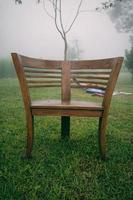 Round wooden chair in the garden with foggy background in the morning. Wooden arm chair photo