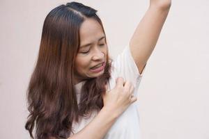 Asian women itching in their armpits photo