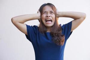 Asian women suffer from work stress. Put your hand on your head photo