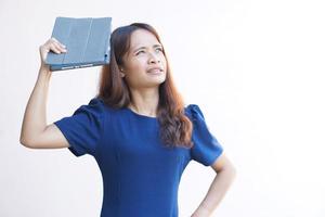 Asian woman looking at a portable computer monitor and devise a business plan photo