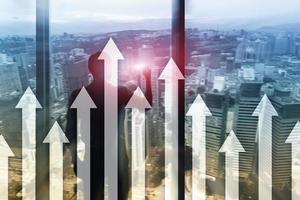 Up arrow graph on skyscraper background. Invesment and financial growth concept. photo