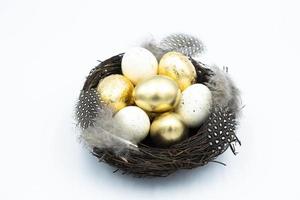 Nest, Easter golden and white eggs photo