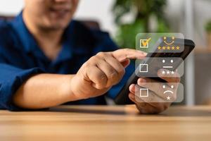 Businessman gives ratings to service experience on a smartphone, Service Provider Satisfaction Ratings and Evaluations,  Satisfaction concept and Customer service photo
