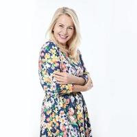 Friendly smiling middle-aged woman i in blue dress solated on white background photo