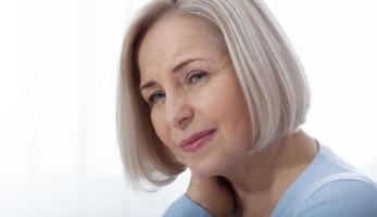 Woman with pain in her neck, medical shot at home. Concept photo with indicating location of the pain.