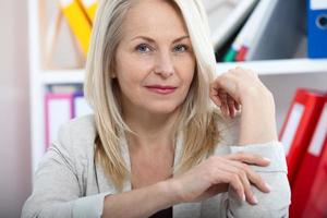 Modern businesswoman. Beautiful middle aged woman looking at camera photo