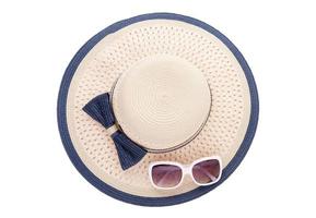 Summer hat with ribbon and sunglasses isolated on white background. Top view and copy space. photo