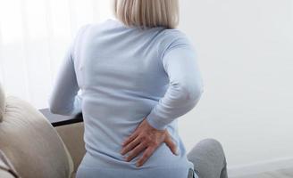 Woman in pain holding her stomach on the right side photo