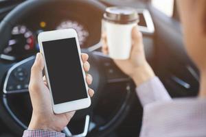 people person drinking paper cup coffee of hot holding hand in a car in the morning not sleepy be energetic while driving. transportation and vehicle concept. empty copy space for text. photo