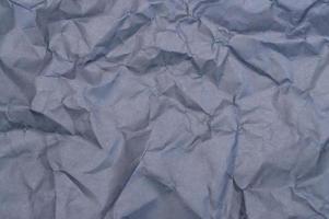 Wrinkled or crumpled black stencil paper or tissue after use in toilet or restroom with large copy space is used for background texture in art work. photo