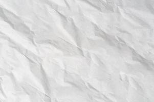 Wrinkled or crumpled white stencil paper or tissue after use in toilet or restroom with large copy space used for background texture in art work photo