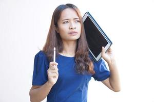 Asian woman looking at a portable computer monitor and devise a business plan photo