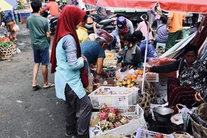 Badung Bali January 13 2023 A buyer is seen buying fresh fruit and vegetables at a traditional market in Bali photo