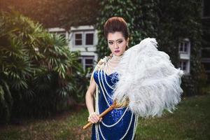 Beautiful lady in luxury blue dress with pearl photo