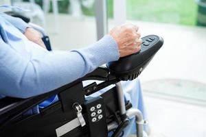 Asian elderly woman disability patient walk with walker in nursing hospital, medical concept. photo