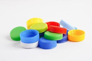 Plastic bottle caps colorful for recycle on white background. photo