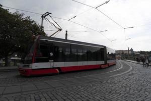 PRAGUE, CZECH REPUBLIC - JULY 15 2019 - Typical red tram of Town full of tourist in summer time photo