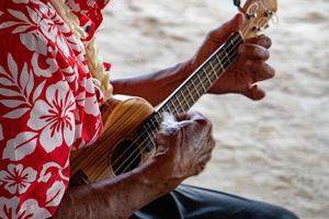 old man hands playing hukulele in french polynesia photo