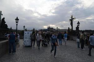 PRAGUE, CZECH REPUBLIC - JULY 15 2019 - Charles Bridge is full of tourist in summer time photo