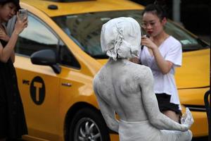 NEW YORK, USA - MAY 27 2018 - living statue performer outside Met photo