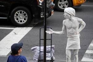 NEW YORK, USA - MAY 27 2018 - living statue performer outside Met photo