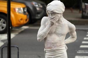 NEW YORK, USA - MAY 27 2018 - living statue performer outside Met photo