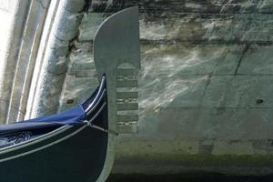 Venice romantic gondola boat passing the bridge photo