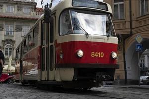 PRAGUE, CZECH REPUBLIC - JULY 15 2019 - Typical red tram of Town full of tourist in summer time photo