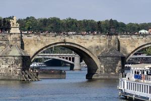 PRAGUE, CZECH REPUBLIC - JULY 15 2019 - Charles Bridge is full of tourist in summer time photo