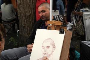 PARIS, FRANCE - OCTOBER 6 2018 - Artist and tourist in Montmartre photo