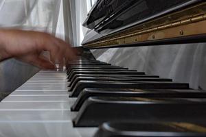 Hands playing piano while moving photo