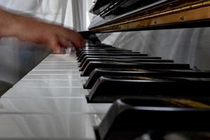 Hands playing piano while moving photo