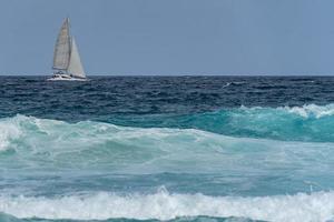 Catamaran in tempest sea waves photo