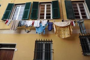 Clothes hanging from italian house in Genoa photo