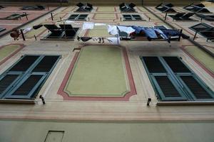 Clothes hanging from italian house in Genoa photo