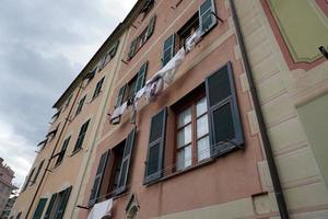 Clothes hanging from italian house in Genoa photo