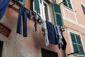Clothes hanging from italian house in Genoa photo