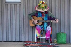 hippy playing guitar on the street photo