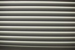 Blinds on window. Leakage of blinds. Window in afternoon. photo