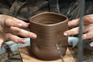 hands while crafting pottery detail close up photo