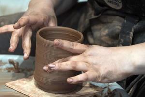 hands while crafting pottery detail close up photo